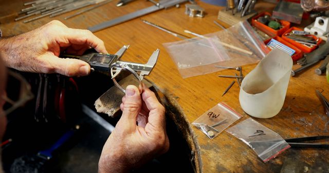 Jeweler using precision caliper measuring silver ring in workshop - Download Free Stock Images Pikwizard.com