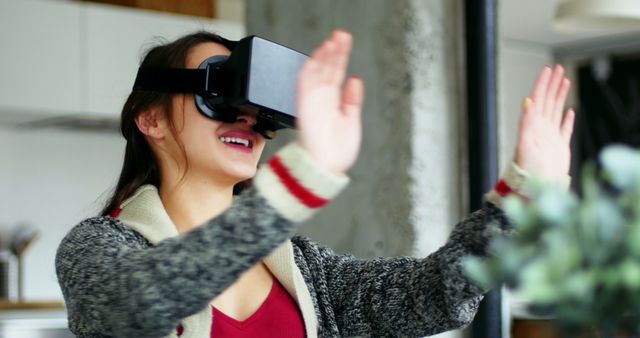 Enthusiastic Woman Using Virtual Reality Headset for Immersive Experience at Home - Download Free Stock Images Pikwizard.com