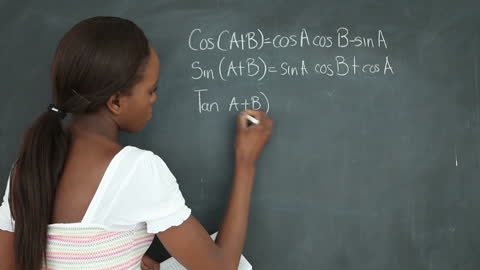 Student Solving Trigonometry Problems on Blackboard in Classroom