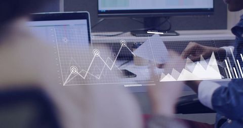 Business Team Analyzing Financial Graphs in Office Environment