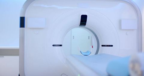 Ct scanner gantry with motorized patient table sliding into bore modern radiology