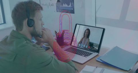 Man in Headset Conducting Laptop Video Call with Biometric Fingerprint Overlay