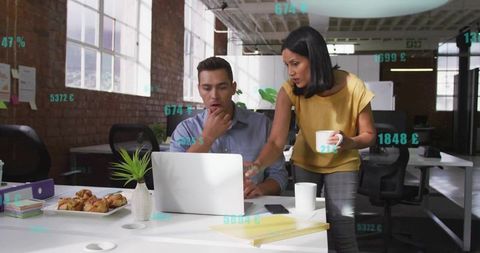 Professional Team Analyzing Data on Office Laptop in Modern Workspace