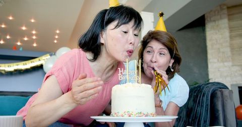 Senior Friends Celebrating Birthday Together at Home Party