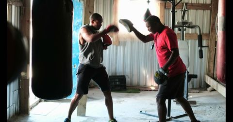 African American Boxer Training with Coach in Rustic Gym - Download Free Stock Images Pikwizard.com