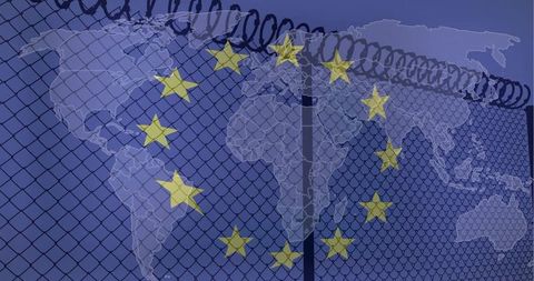 European Union Border Security Concept with Razor Wire Chainlink Fence and World Map