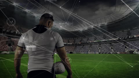 Soccer Player Holding Ball on Tech-Enhanced Stadium Field