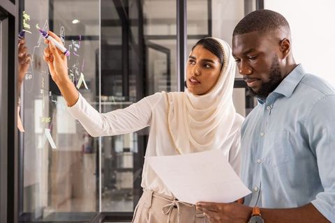 Diverse Professionals Collaborating and Brainstorming in Modern Office