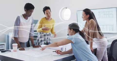 Female team collaborating on blueprints in modern office during architecture planning session