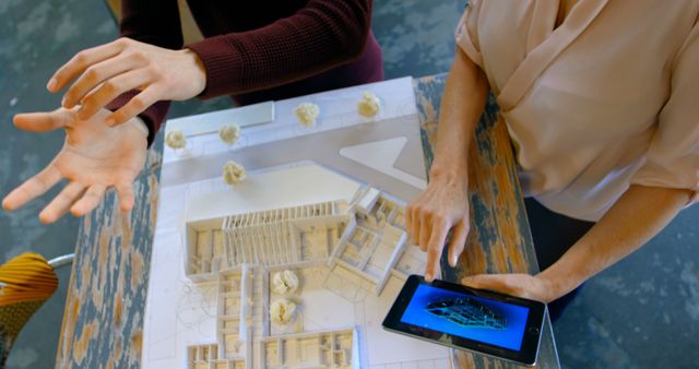 Architects Examining Detailed Building Model While Using Digital Tablet - Download Free Stock Images Pikwizard.com