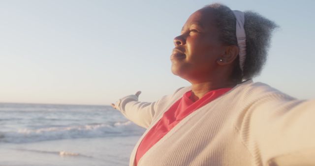 Happy Senior Woman Enjoying Beach Sunset with Open Arms - Download Free Stock Images Pikwizard.com