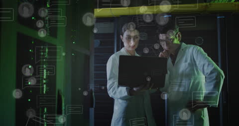 Scientists Analyzing Data on Laptop in Server Room