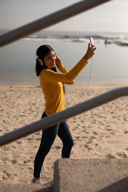 Biracial woman taking picture at the beach - Download Free Stock Photos Pikwizard.com