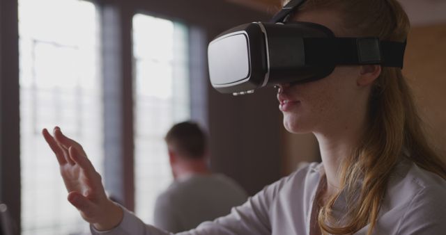 Woman Immersed in Virtual Reality Wearing VR Headset Indoors - Download Free Stock Images Pikwizard.com