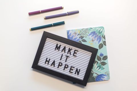 Motivational Letter Board with Colorful Pens on White Background