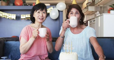 Senior Friends Celebrating Birthday at Home with Cake and Coffee