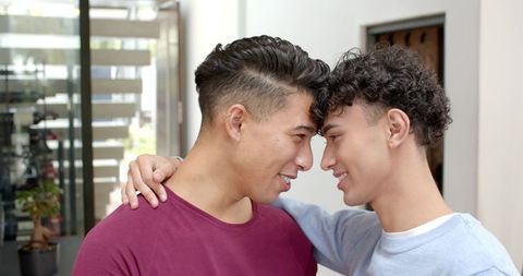 Intimate Moment Between Young Men in Modern Entrance Way