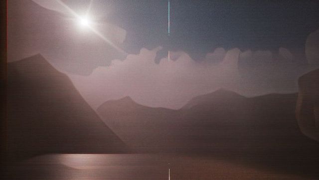 Shimmering Mountain Ridges Reflected in Tranquil Dawn Waters