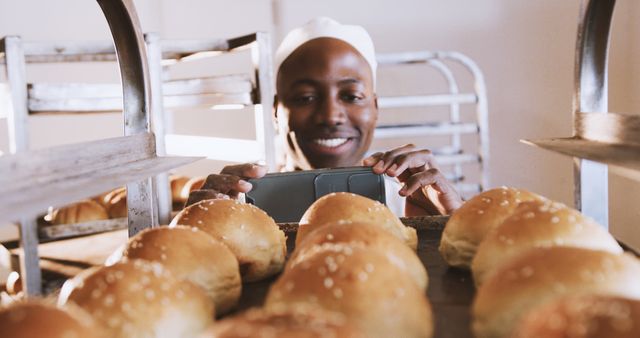 Smiling Baker Taking Photo of Freshly Baked Bread Rolls in Bakery - Download Free Stock Images Pikwizard.com