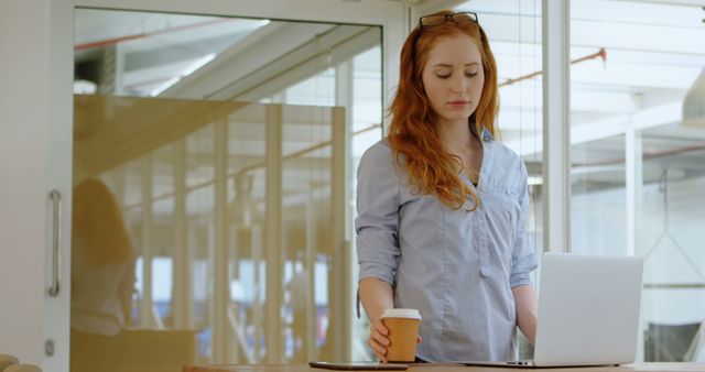 Female Professional Working on Laptop with Coffee in Office - Download Free Stock Images Pikwizard.com