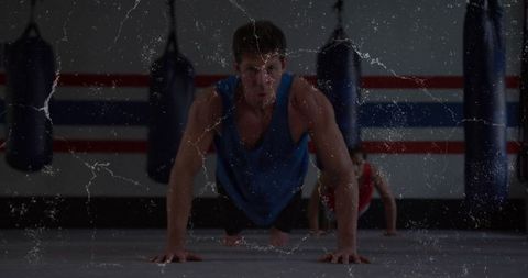 Men doing pushup exercises in boxing gym for strength conditioning