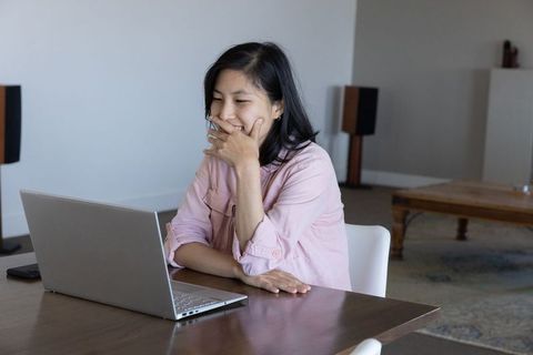 Woman Using Laptop in Stylish Home Office Setting