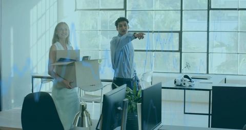 Start-up team moving into modern loft office pointing at new workspace with monitors