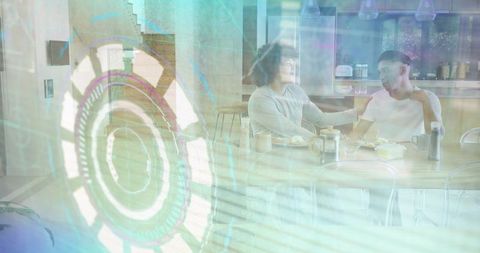 Two men chatting at kitchen table with holographic ar overlay, casual conversation