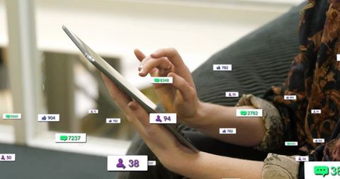 Tapping tablet screen with social media notification badges, adult woman hands close-up