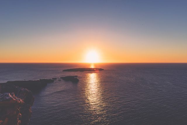 Serene Ocean Sunset Over Small Island - Download Free Stock Photos Pikwizard.com