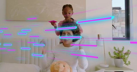 Mother and daughter bonding on bed with neon light streaks, brushing hair, holding teddy