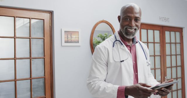 Smiling Doctor in White Coat with Tablet in Modern Office - Download Free Stock Images Pikwizard.com