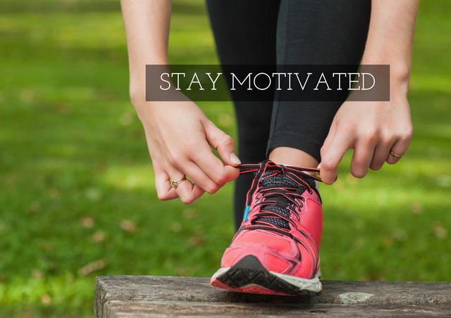 This image shows a woman tying her running shoe in a park, with the text 'Stay Motivated' overlayed. It is perfect for use in fitness blogs, motivational posters, health and wellness websites, and social media posts promoting an active lifestyle.