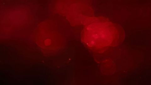Crimson bokeh glow with painterly halos and smoky abstract background