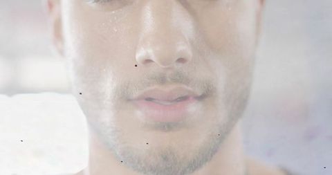 Closeup lower face of young man with parted lips stubble mustache soft focus hazy studio
