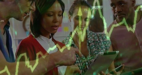 Team analyzing stock market trends with technology