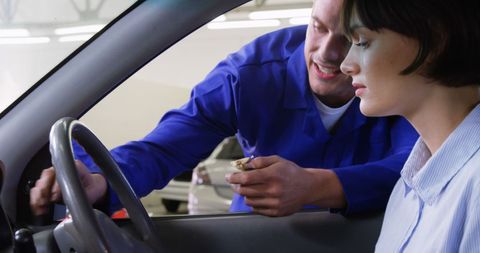 Mechanic Assisting Woman with Car Maintenance Guidance - Download Free Stock Images Pikwizard.com