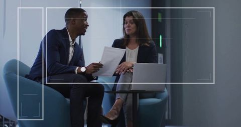 Two Professionals Collaborating in Corporate Lounge