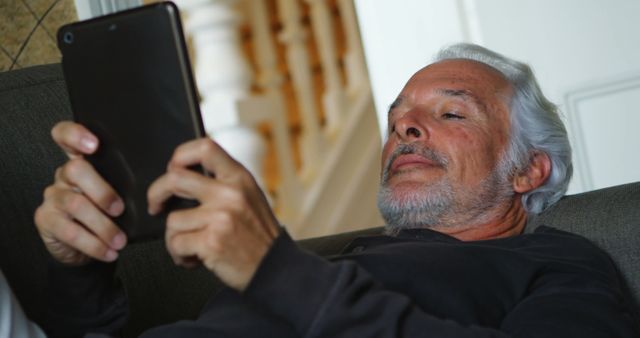 Senior man relaxing at home using tablet - Download Free Stock Images Pikwizard.com