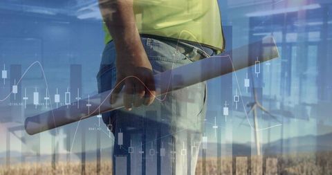 Engineer Analyzing Sustainable Energy with Overlaid Charts