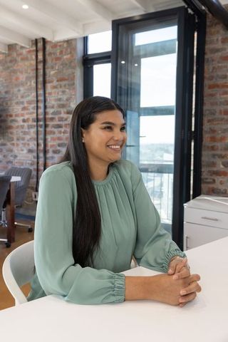 Professional Woman Hosting Engaging Office Meeting at Modern Workplace