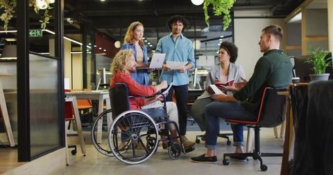 Diverse team meeting in modern open-plan workspace