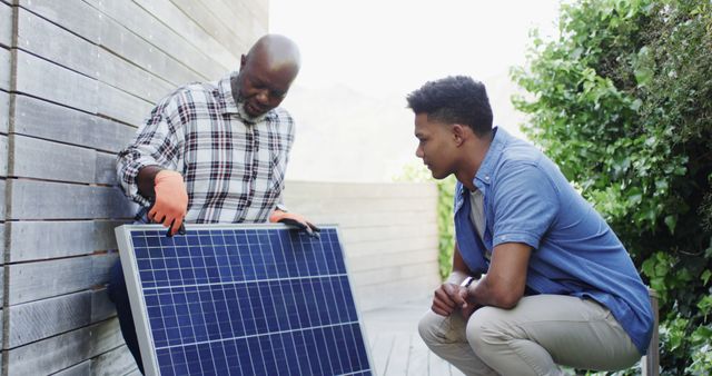 Two Diverse Men Installing Solar Panel on Building Exterior - Download Free Stock Images Pikwizard.com