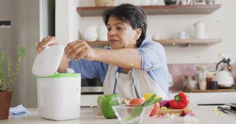 Senior Woman Cooking with Fresh Vegetables in Rustic Home Kitchen