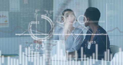 Two professional women analyzing data on laptop with digital analytics overlays and charts