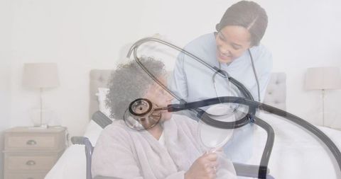 Senior Woman in Wheelchair With Smiling Doctor and Stethoscope Overlay