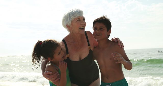 Grandmother Hugging Grandchildren at the Beach - Download Free Stock Images Pikwizard.com