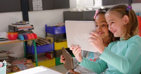 Students Engaged with Tablet Technology in Classroom Learning