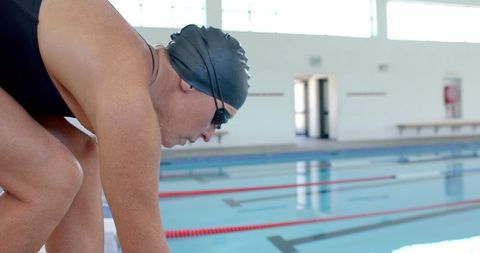 Focused Swimmer Preparing for Dive in Indoor Pool - Download Free Stock Images Pikwizard.com