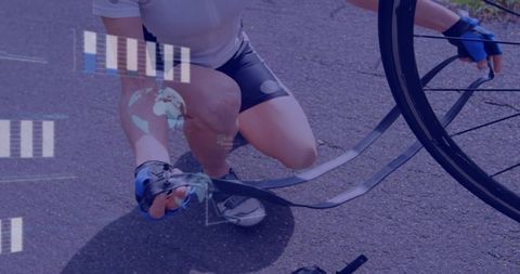 Cyclist fixing inner tube on roadside adventure